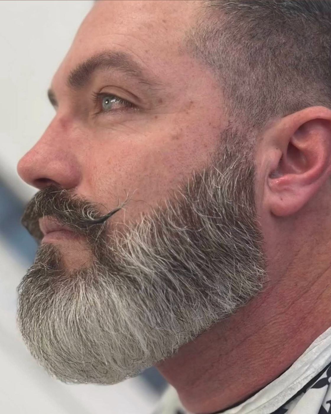 Neatly groomed grey beard and side profile