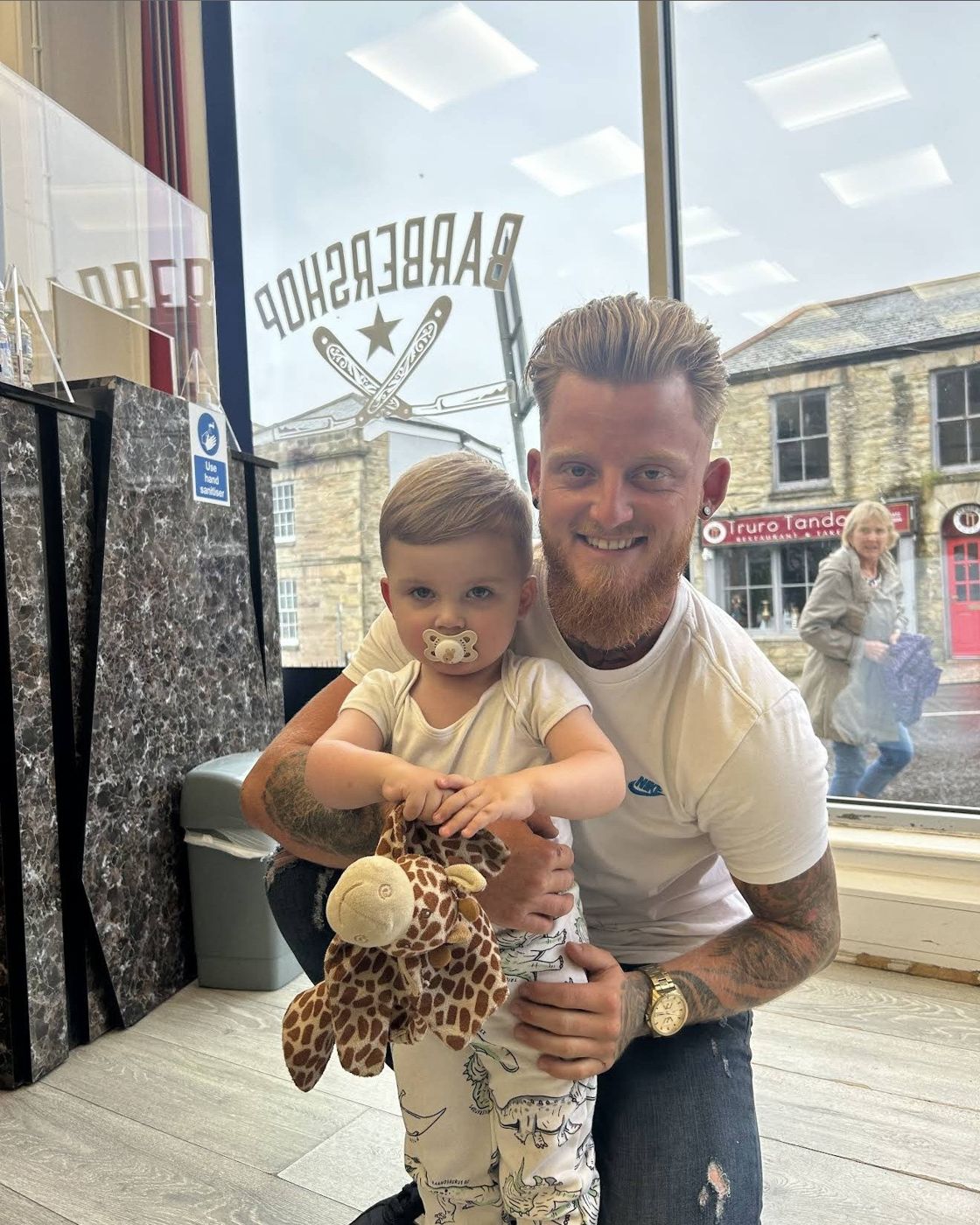 A barber with a young customer inside Lemon Street Barbers